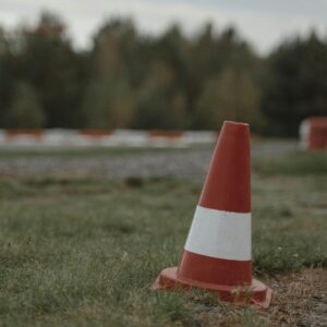 Orange and White Traffic Cone on Green Grass Field