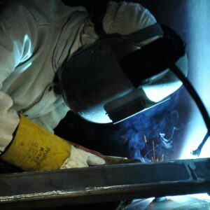 A Person Welding a Metal